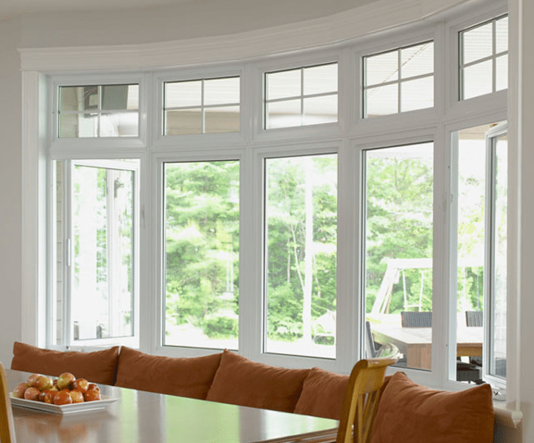 5 bow windows viewed from the inside next to a dinning room table