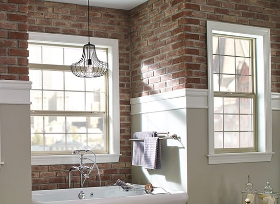 This shows a single hung window installed in a brick wall above a kitchen sink.